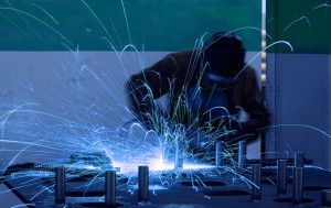 welding worker with sparks arcing